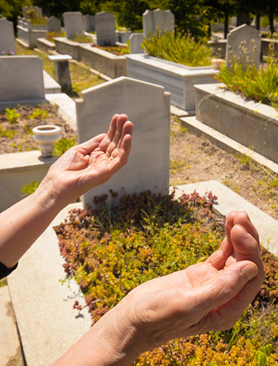 About us - Mission Hand Praying at Tombstones